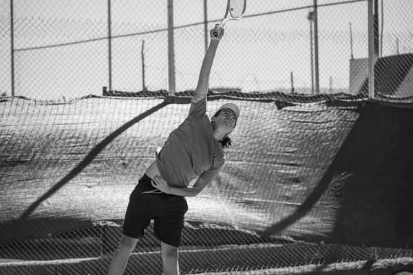 Person focused on executing a precise physical movement.